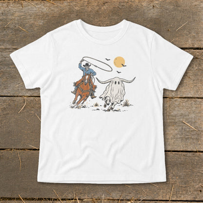 Cowboy lassoing a ghost wearing bull horns under a setting sun.