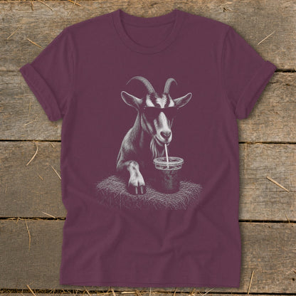Maroon t-shirt with a graphic of a goat wearing sunglasses drinking from a cup.