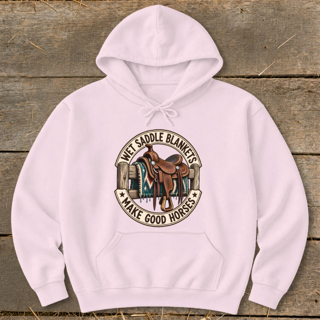 Pink hoodie with circular graphic of a saddle and blanket, saying "Wet Saddle Blankets Make Good Horses".