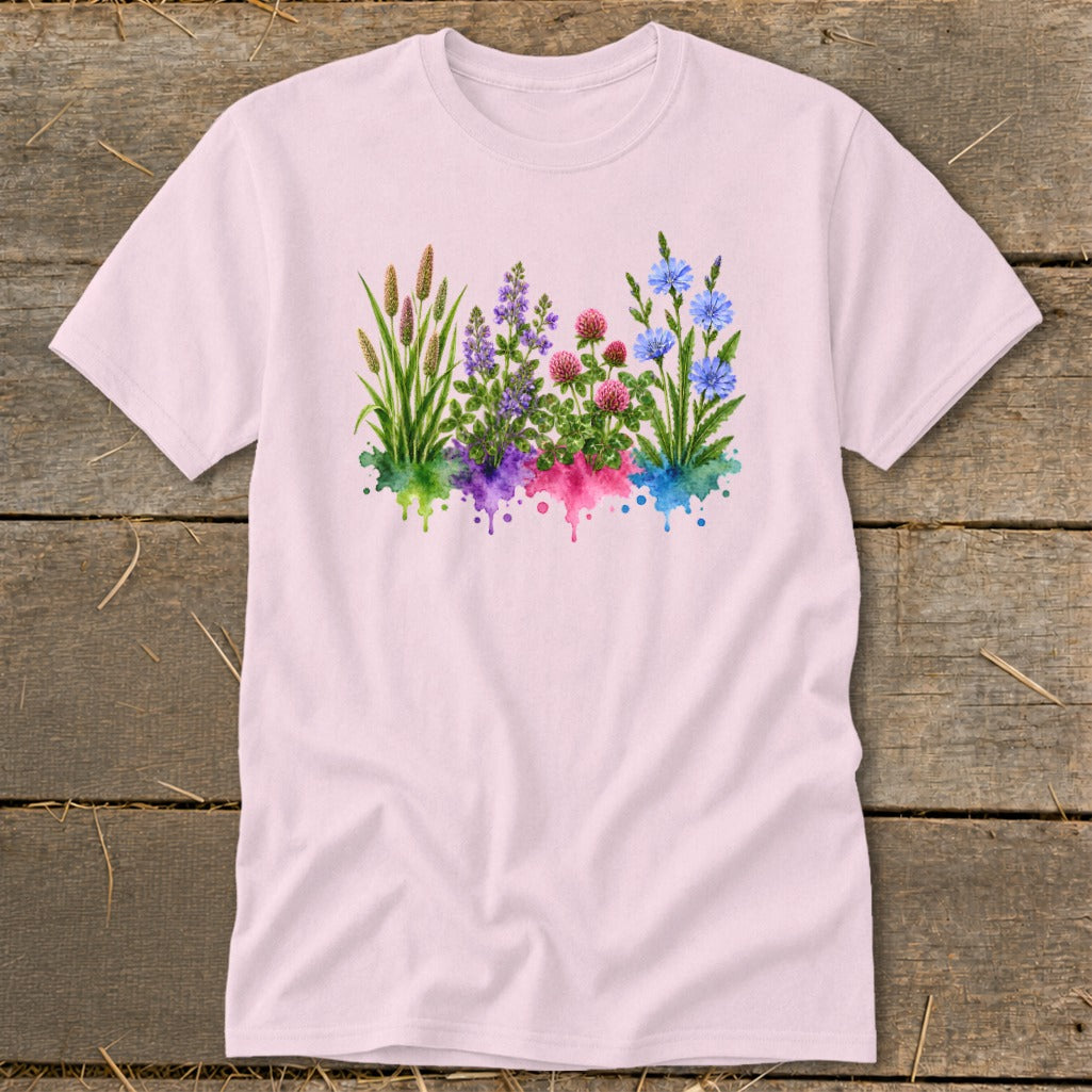 A light pink short-sleeve t-shirt features a watercolor botanical print of wildflowers and grasses.