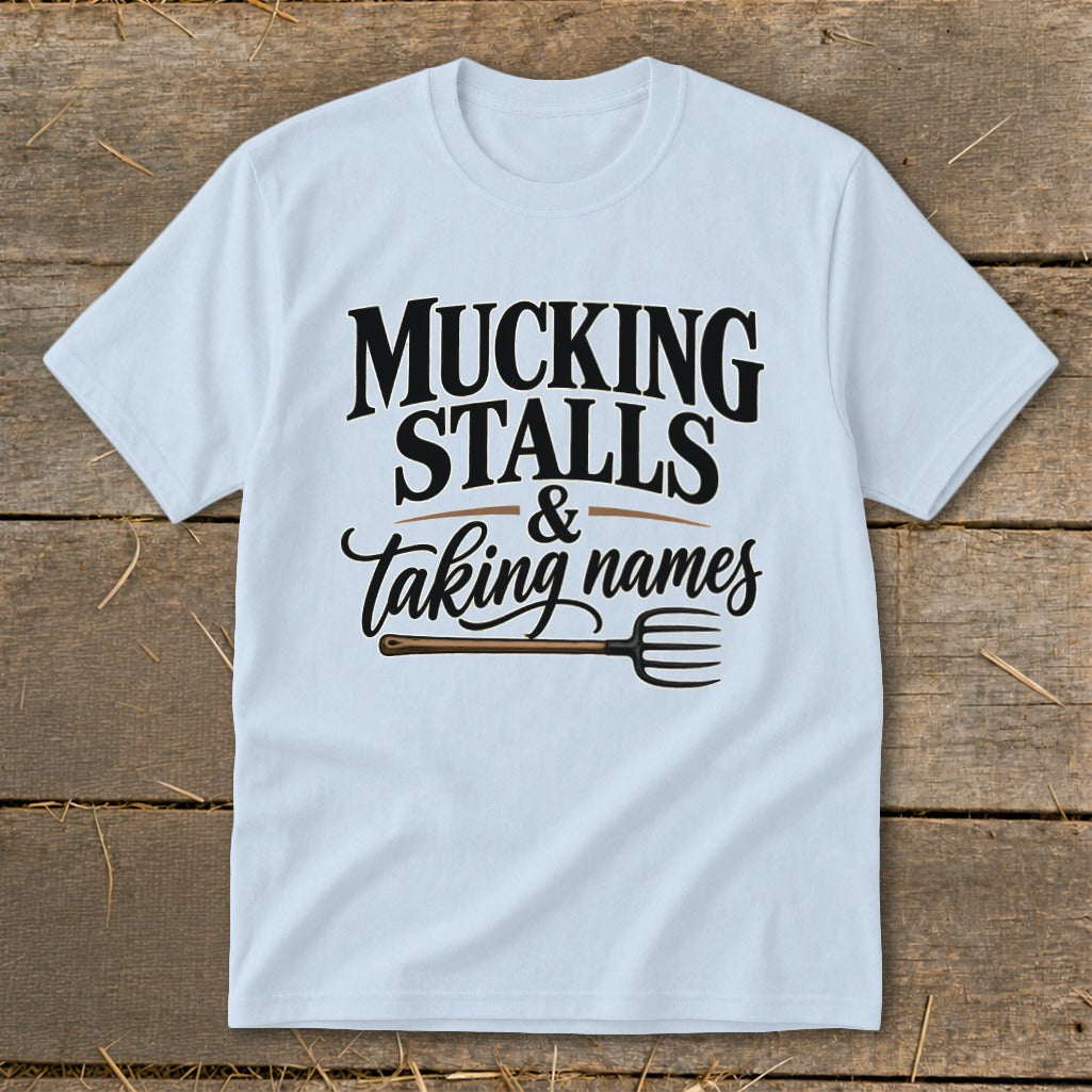 Light blue t-shirt with "MUCKING STALLS & Taking names" and a pitchfork graphic.