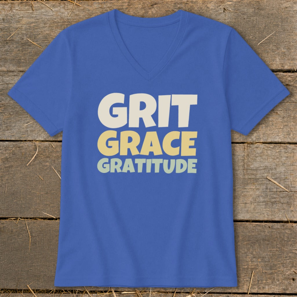 A blue V-neck t-shirt with the words GRIT GRACE GRATITUDE printed on the front.