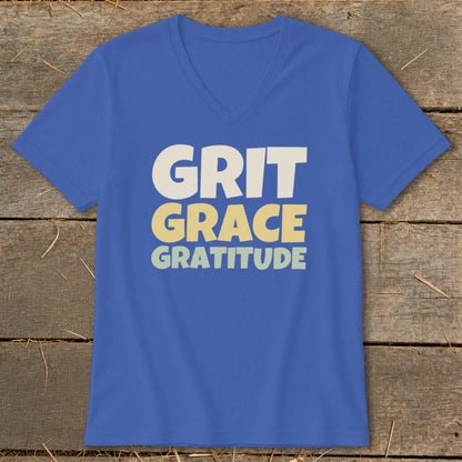 A blue V-neck t-shirt with the words GRIT GRACE GRATITUDE printed on the front.