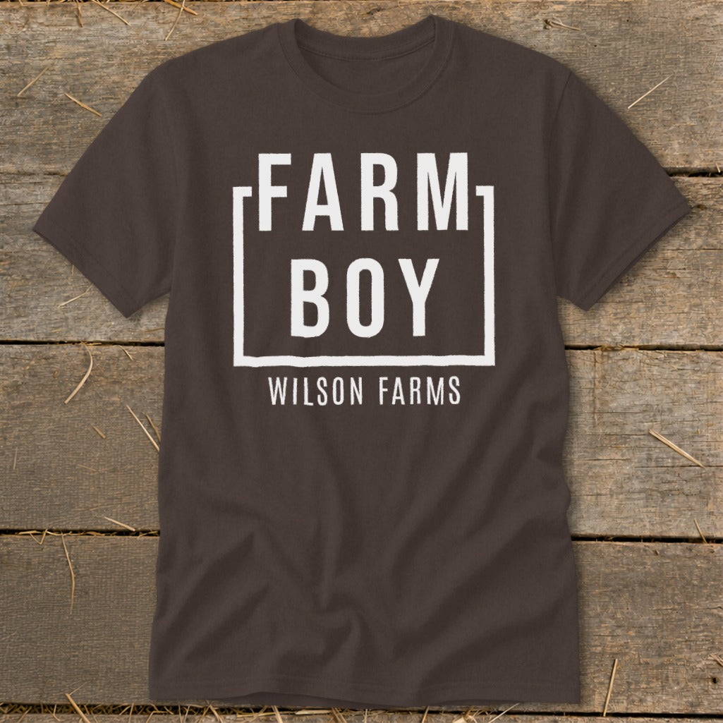 Brown t-shirt with white text "FARM BOY WILSON FARMS" in a box.