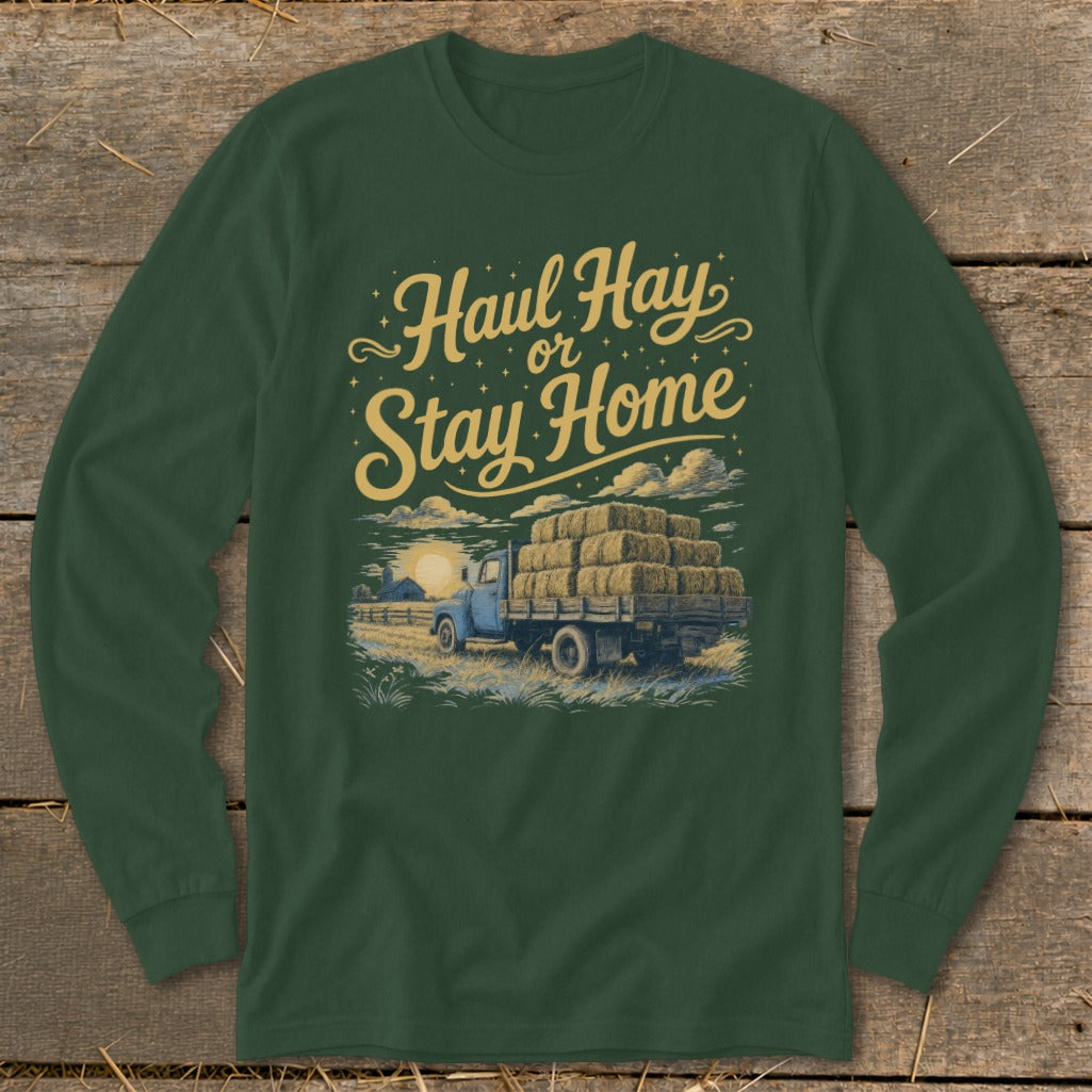 Green long-sleeve shirt with "Haul Hay or Stay Home" text and illustration of a truck with hay bales.