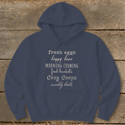 Navy hoodie with white text: fresh eggs, happy hens, morning crowing, feed buckets, cozy coops, muddy boots.