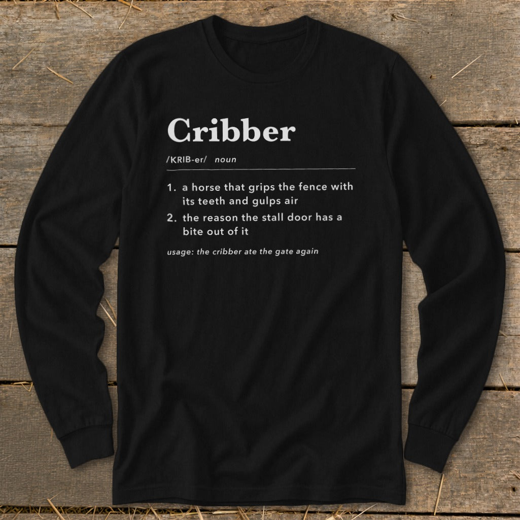 A black long-sleeve t-shirt features a dictionary-style definition of the word cribber in white text.