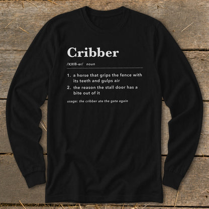 A black long-sleeve t-shirt features a dictionary-style definition of the word cribber in white text.