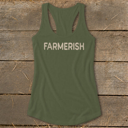 Olive green tank top with "FARMERISH" text, laid on rustic wood with straw.