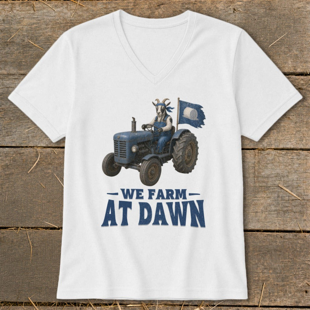 Goat in overalls drives tractor with flag, text reads "We Farm At Dawn".