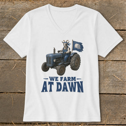 Goat in overalls drives tractor with flag, text reads "We Farm At Dawn".
