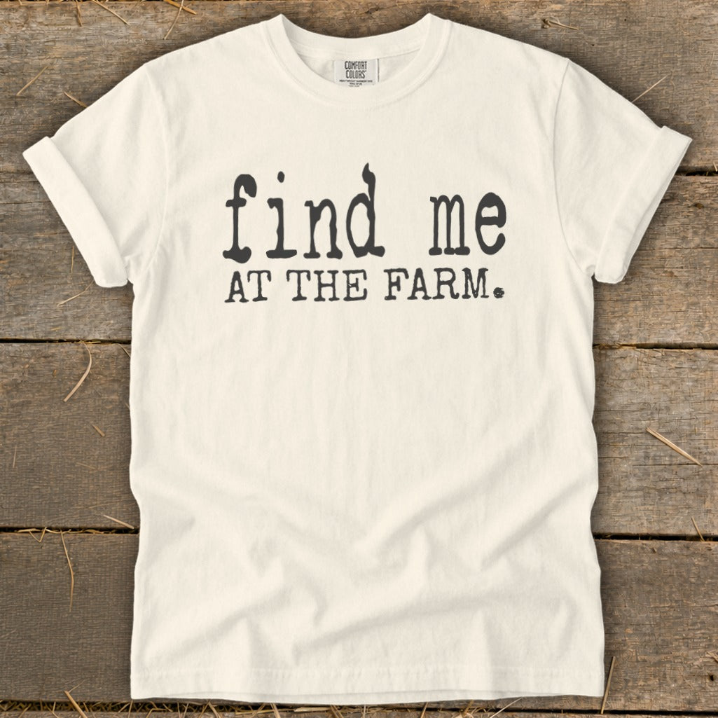 Cream t-shirt with black text "find me AT THE FARM."