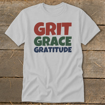 A light gray t-shirt featuring the stacked text Grit, Grace, and Gratitude in red, green, and blue.