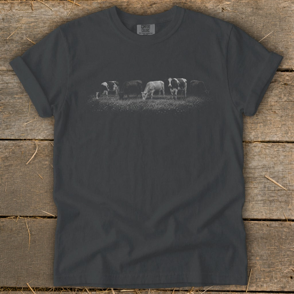 T-shirt with a row of cows grazing in a field.