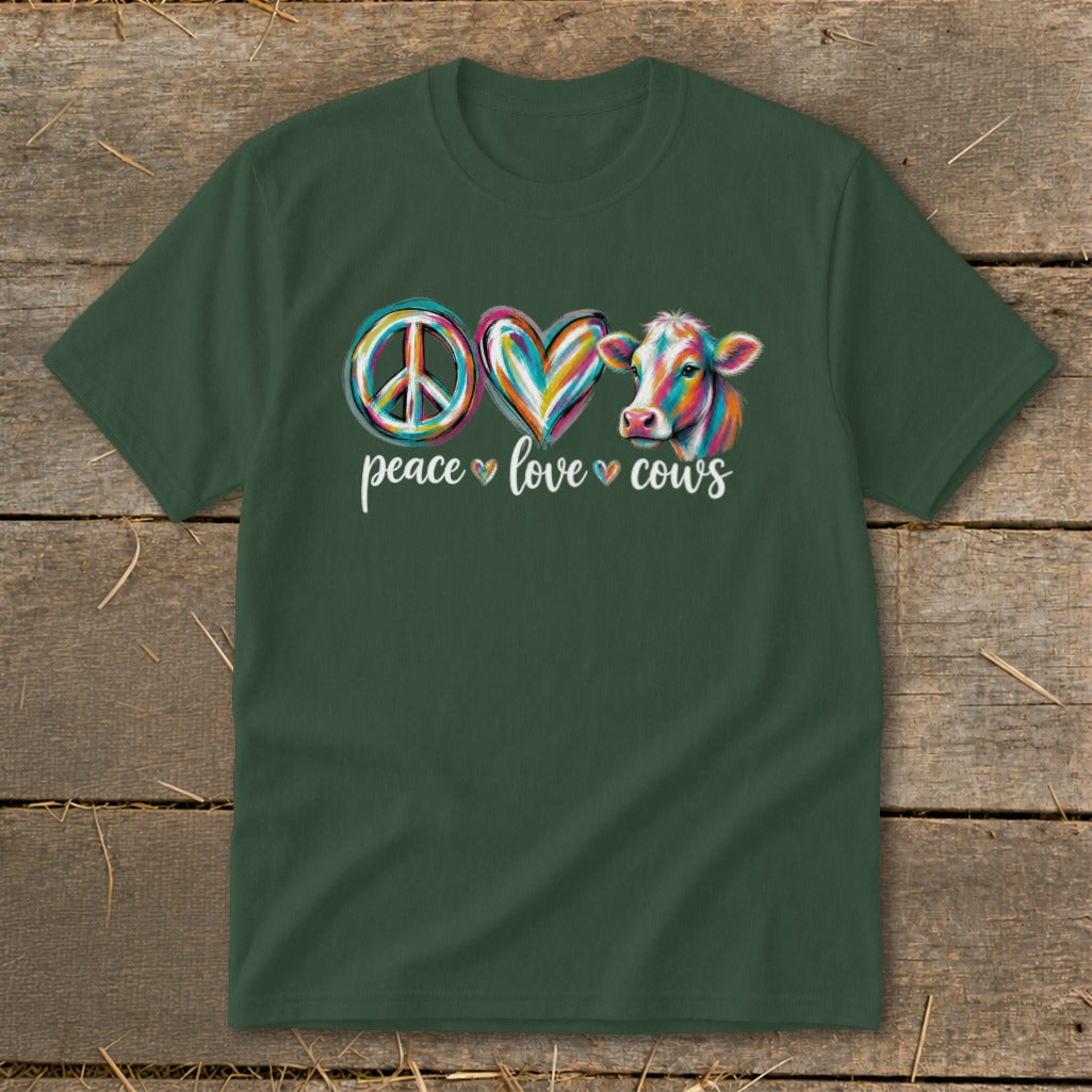 Green t-shirt with peace sign, heart, and colorful cow graphic and text.