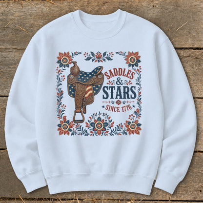 White sweatshirt with a saddle, flowers, and text "SADDLES & STARS SINCE 1776".