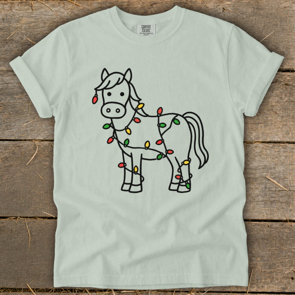 Light blue t-shirt with a cartoon horse outline decorated with Christmas lights.