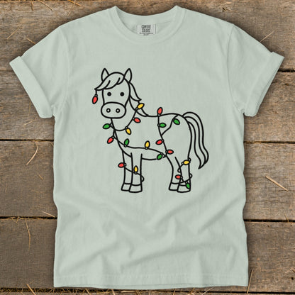 Light blue t-shirt with a cartoon horse outline decorated with Christmas lights.