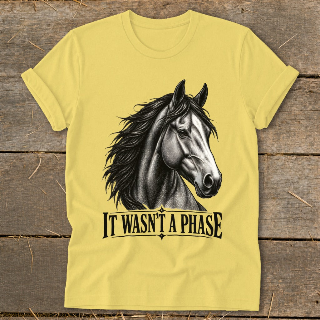 Yellow t-shirt with a black and white horse illustration and the text "IT WASN'T A PHASE".