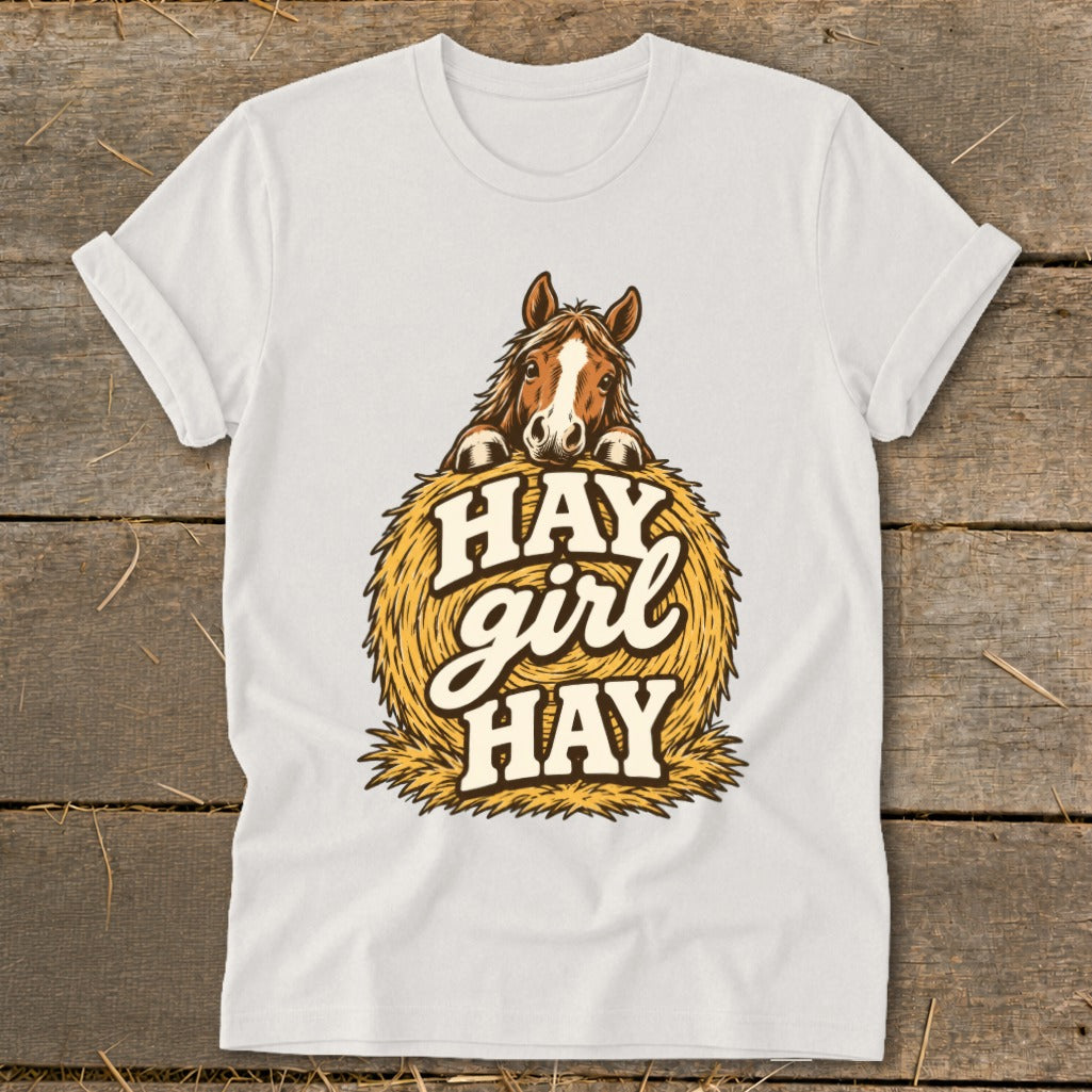 White t-shirt with horse peeking over a hay bale, saying "Hay girl hay".