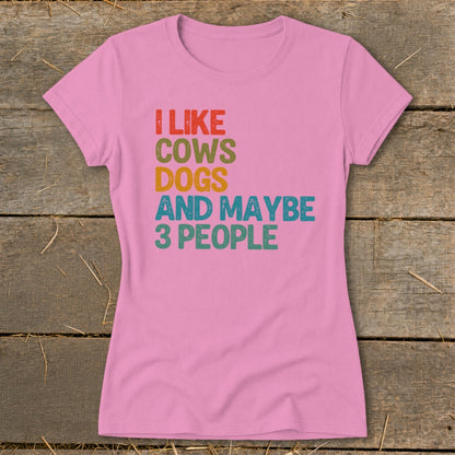 Pink t-shirt with "I Like Cows Dogs And Maybe 3 People" text.