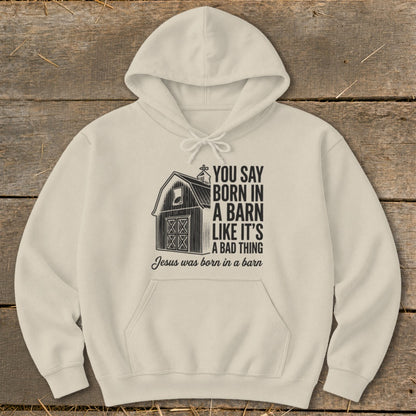 Cream hoodie with barn graphic and text "You say born in a barn like it's a bad thing. Jesus was born in a barn."