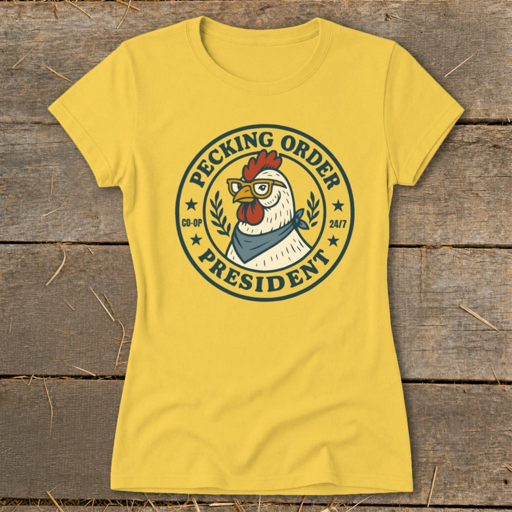 Yellow t-shirt with a circular graphic of a chicken wearing glasses and a bandana, labeled "Pecking Order President".