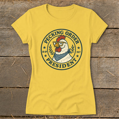Yellow t-shirt with a circular graphic of a chicken wearing glasses and a bandana, labeled "Pecking Order President".