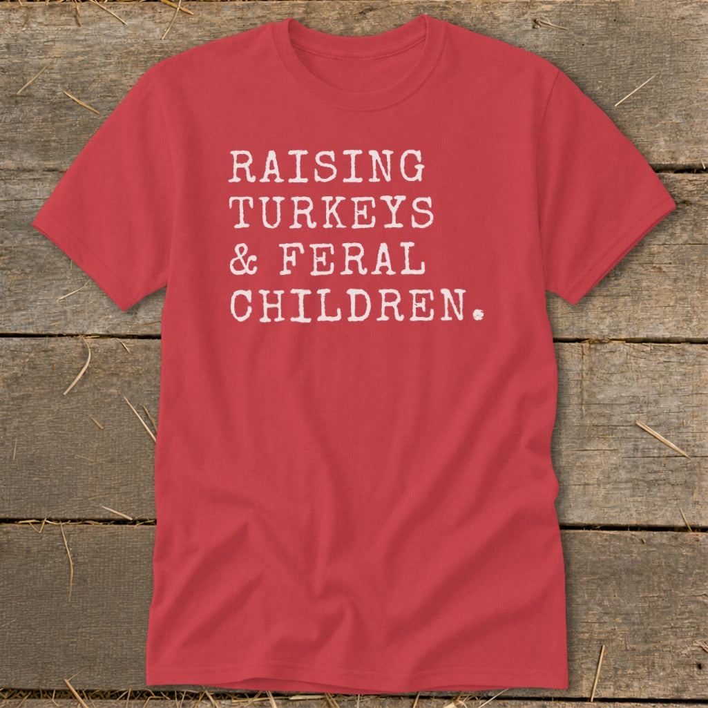 Red t-shirt with white text "RAISING TURKEYS & FERAL CHILDREN."
