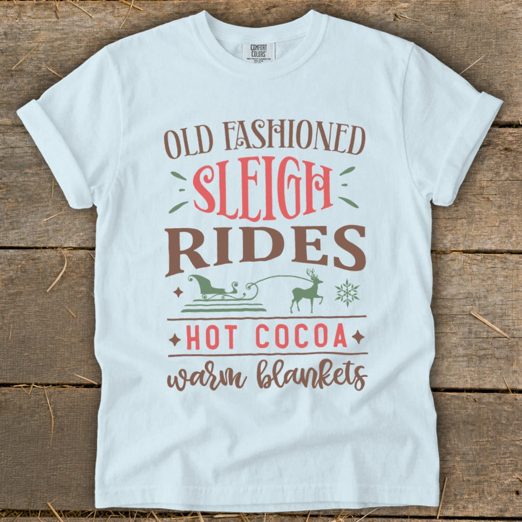 White t-shirt with "Old Fashioned Sleigh Rides" and "Hot Cocoa warm blankets" text.