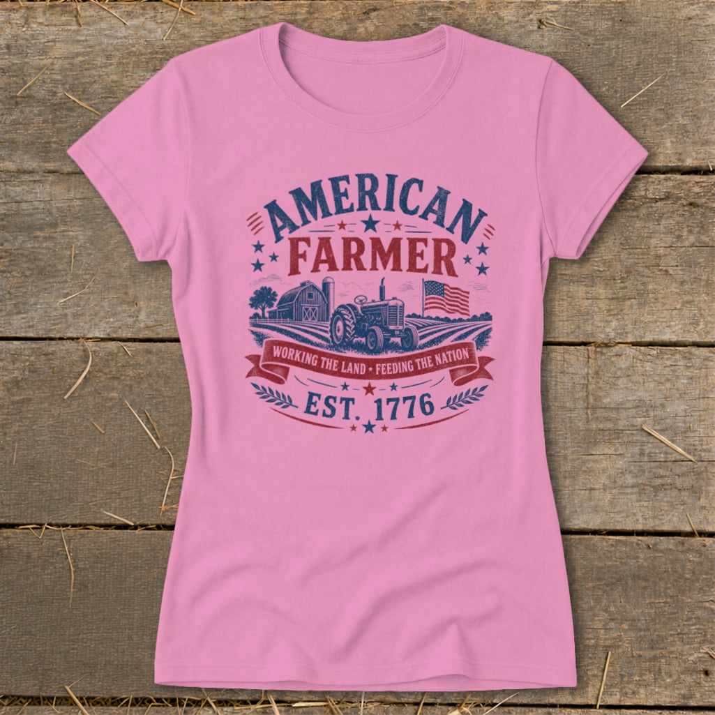 Pink t-shirt with "American Farmer" graphic featuring tractor, barn, and flag.