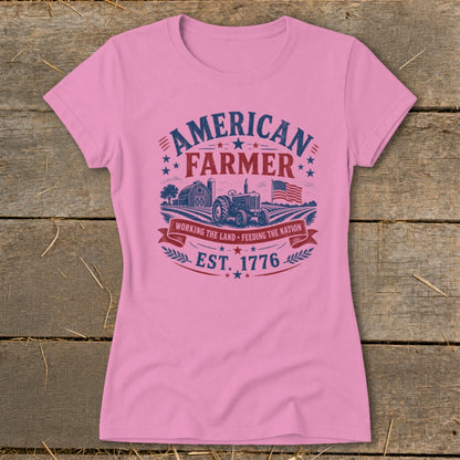 Pink t-shirt with "American Farmer" graphic featuring tractor, barn, and flag.