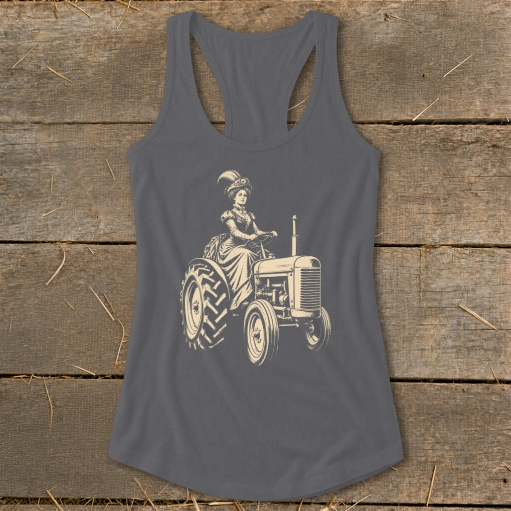 Vintage-style woman in a long dress and feathered hat driving a tractor.