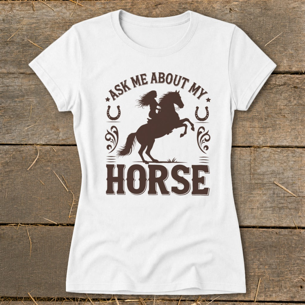 White t-shirt with brown graphic of a woman on a rearing horse and text "Ask Me About My Horse".