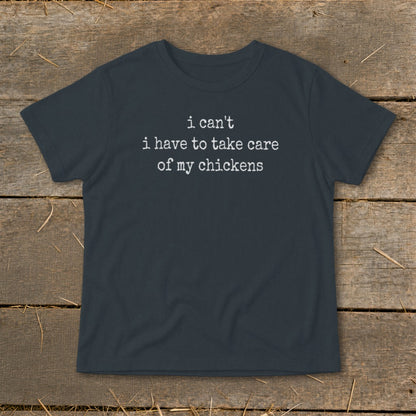Dark gray t-shirt with white text that reads "i can't i have to take care of my chickens".