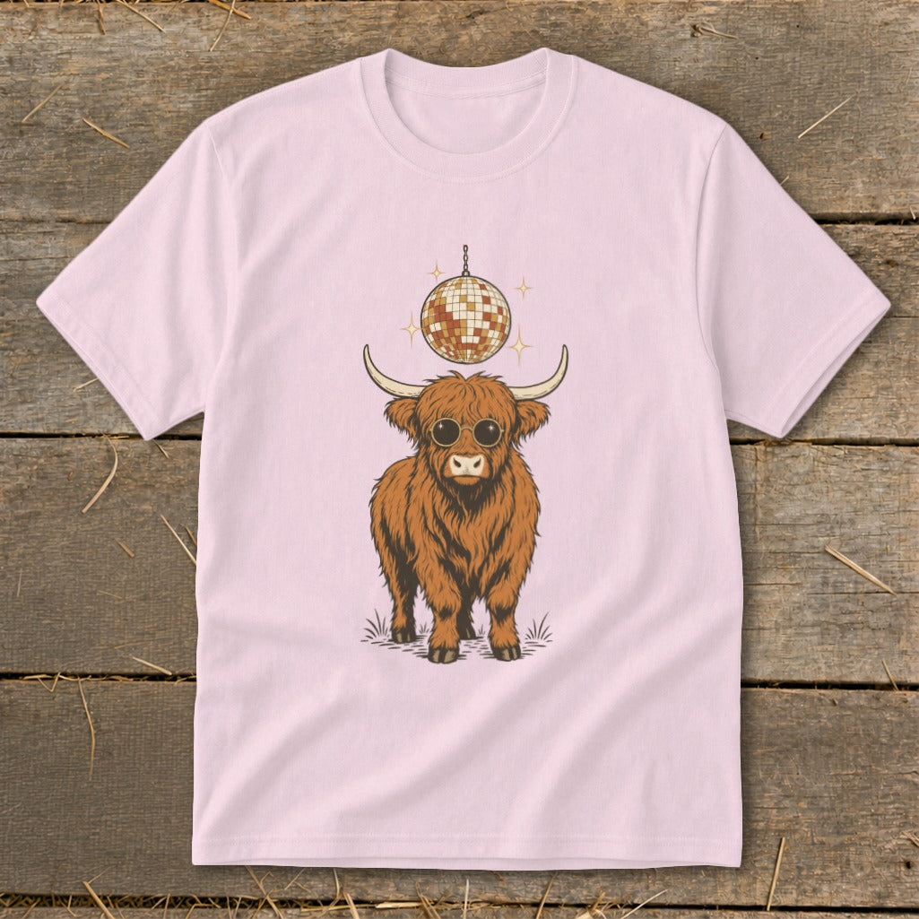 Highland cow wearing sunglasses with disco ball above on pink t-shirt.
