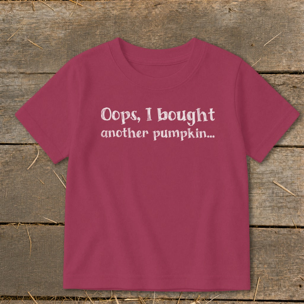 Pink t-shirt with white text "Oops, I bought another pumpkin..."