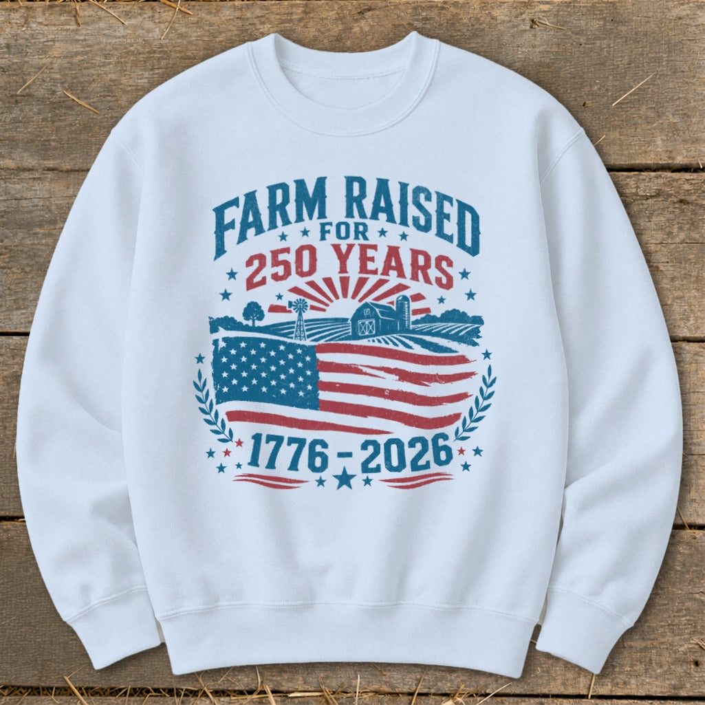 White sweatshirt with "Farm Raised for 250 Years 1776-2026" text and farm graphic.