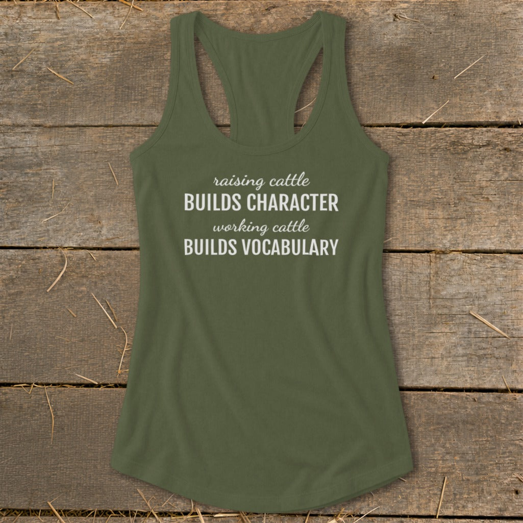 Olive green racerback tank top with white text reading "raising cattle BUILDS CHARACTER working cattle BUILDS VOCABULARY".