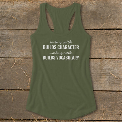 Olive green racerback tank top with white text reading "raising cattle BUILDS CHARACTER working cattle BUILDS VOCABULARY".
