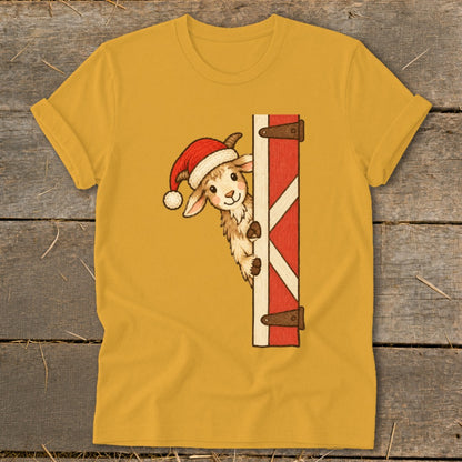 Yellow t-shirt with a cartoon goat wearing a Santa hat peeking around a barn door.
