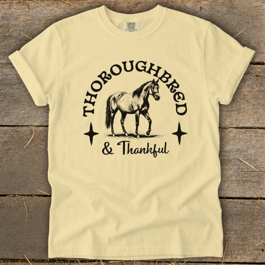 Pale yellow t-shirt with "Thoroughbred & Thankful" text and horse graphic.