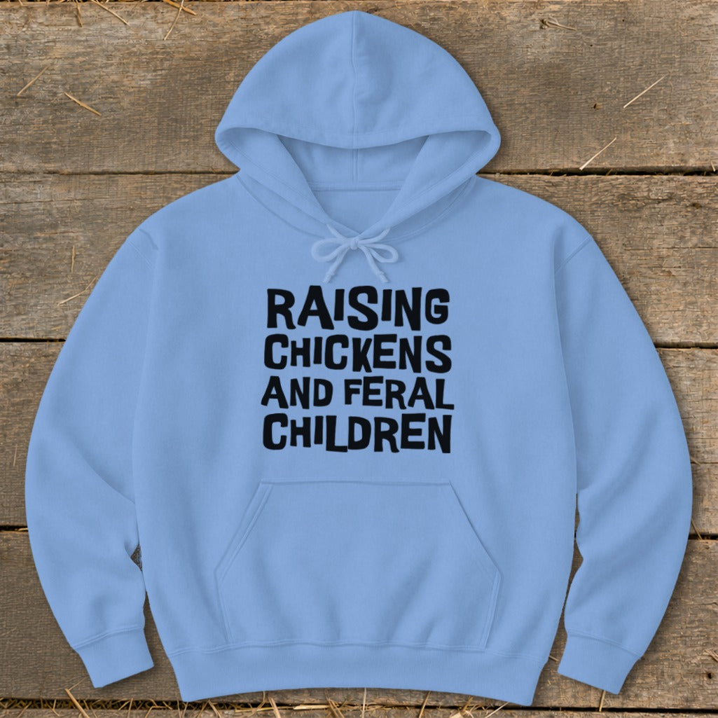 Light blue hooded sweatshirt with "RAISING CHICKENS AND FERAL CHILDREN" printed in black.