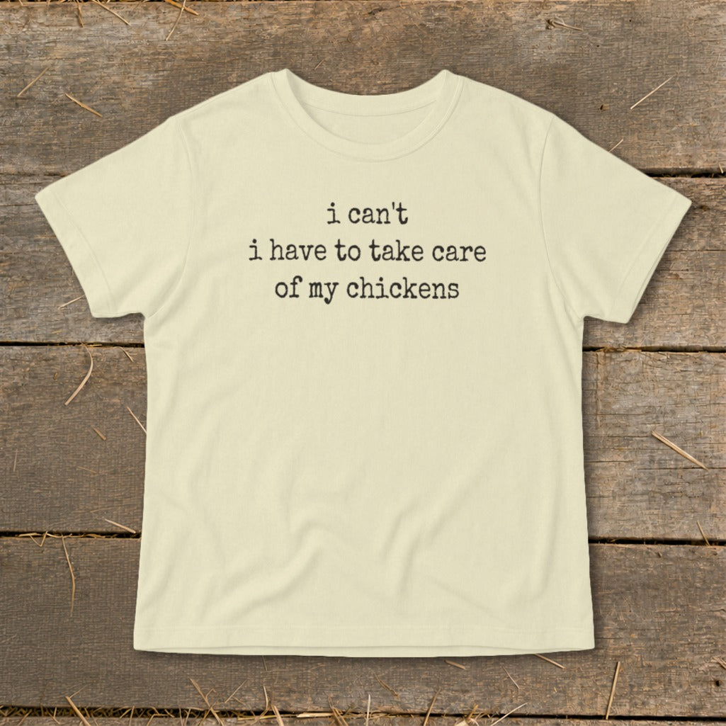 Cream t-shirt with black text reading "i can't i have to take care of my chickens".