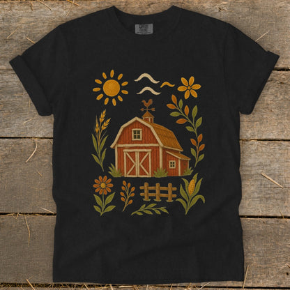 Black t-shirt with a rustic farm graphic featuring a barn, sun, and flowers.