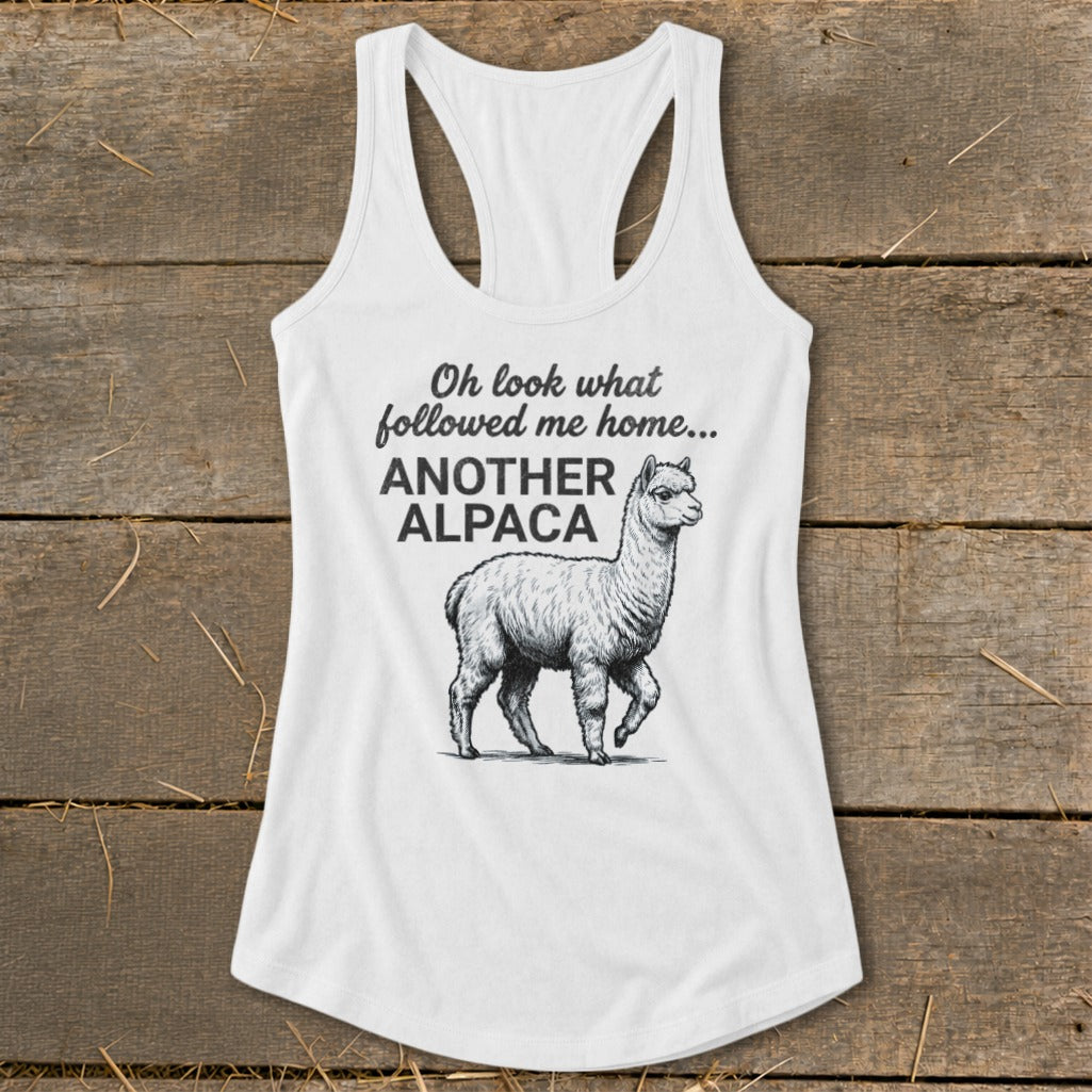 White tank top with alpaca graphic and text "Oh look what followed me home... ANOTHER ALPACA".