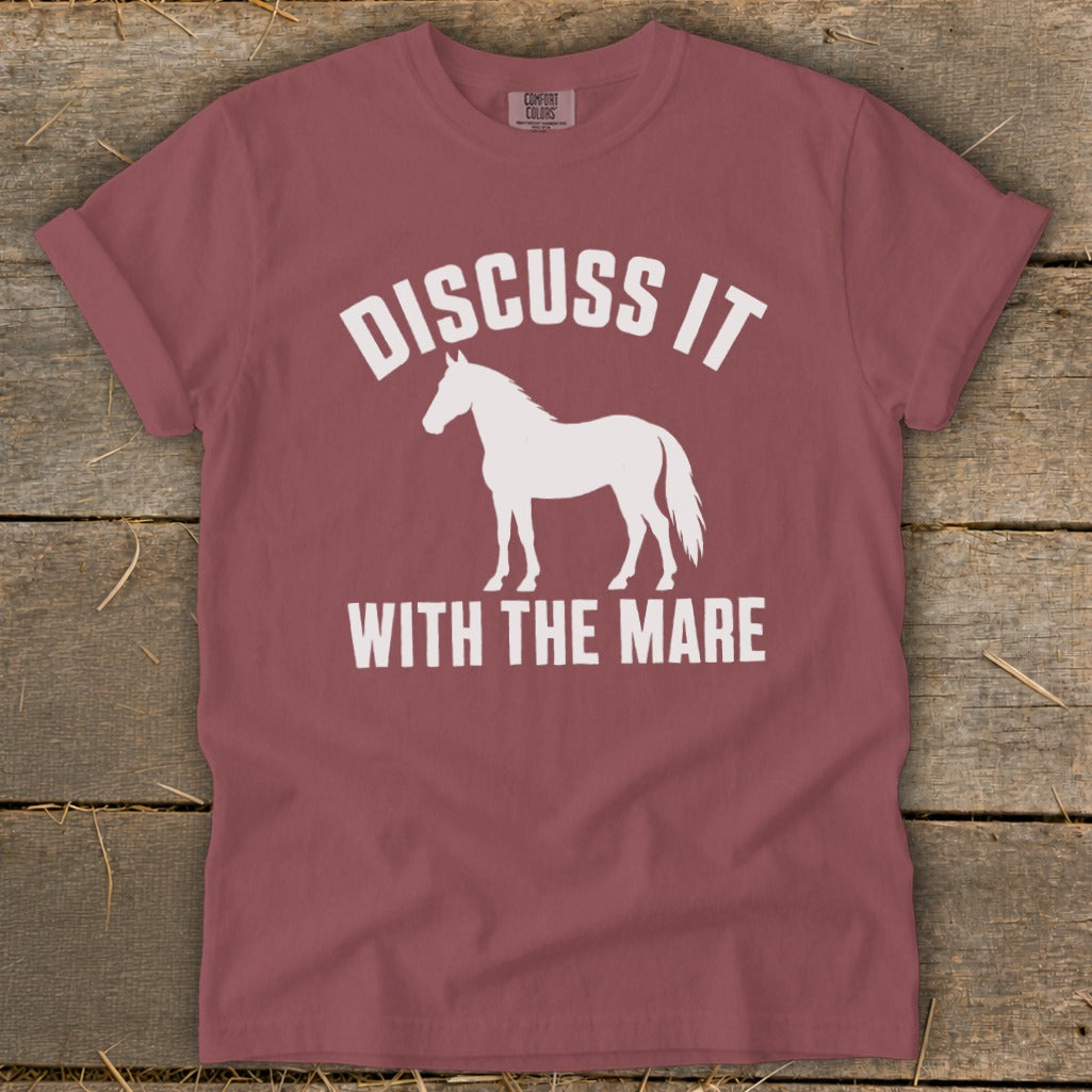 Maroon t-shirt with white graphic of horse and text "DISCUSS IT WITH THE MARE."