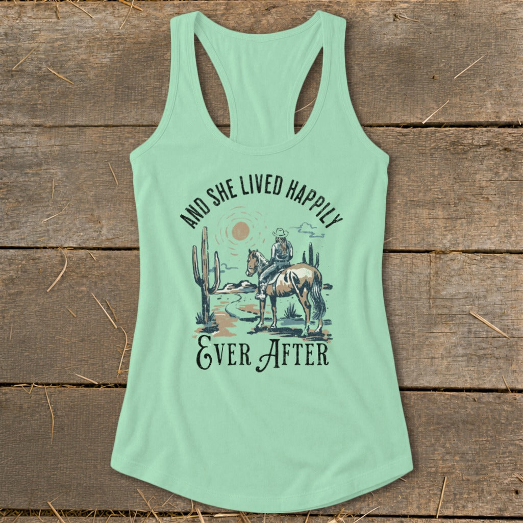 Light green tank top with desert scene, horse, rider, and text "And she lived happily ever after".