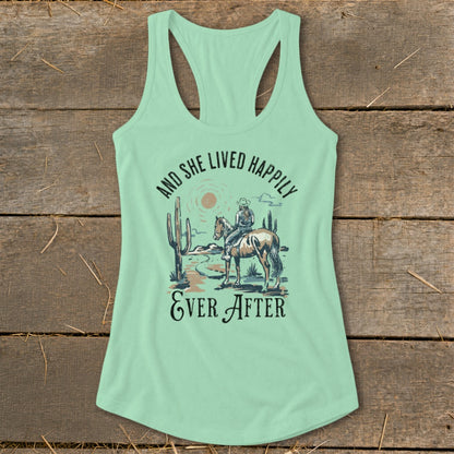 Light green tank top with desert scene, horse, rider, and text "And she lived happily ever after".