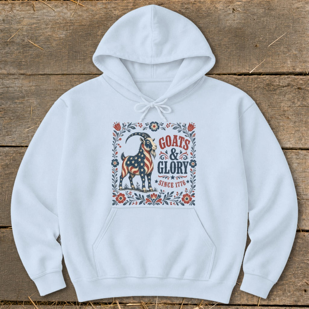 White hoodie with graphic of a goat adorned with the American flag, text "Goats & Glory Since 1776".